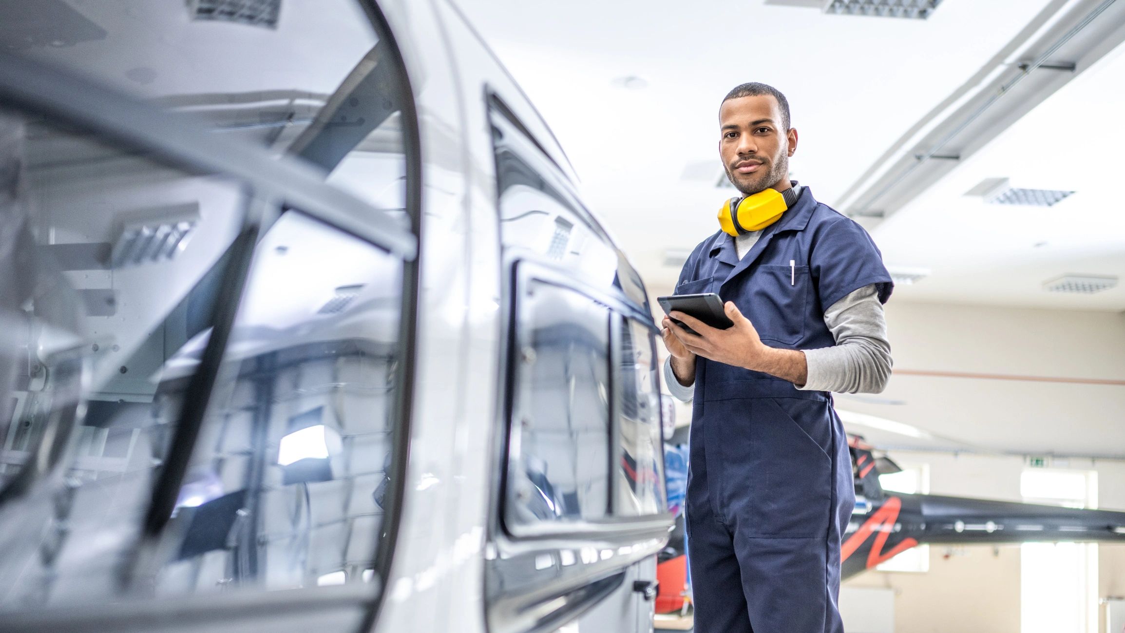 Engineer in an aerospace hangar reviewing operations