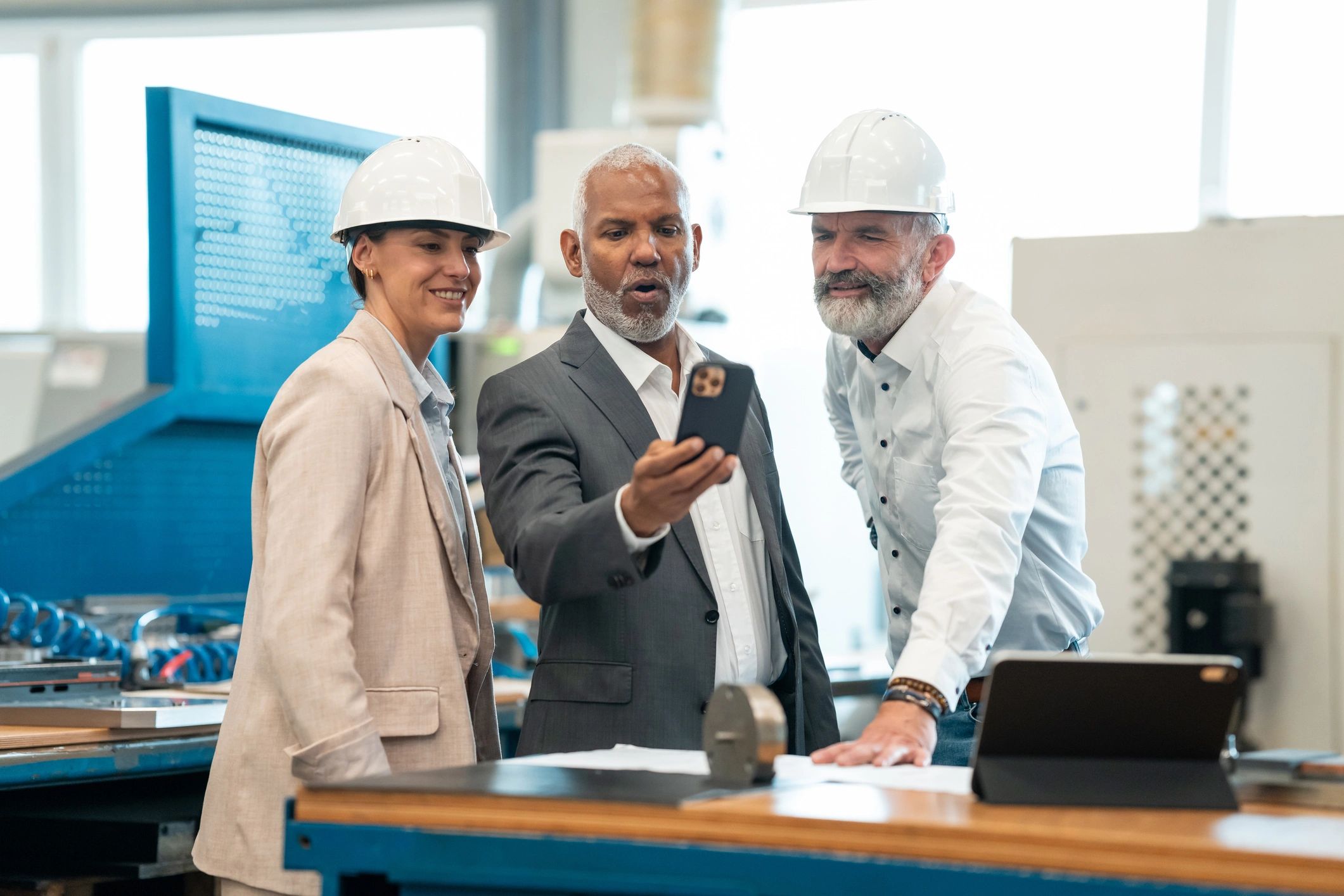 Manufacturing team reviewing production plans on the factory floor