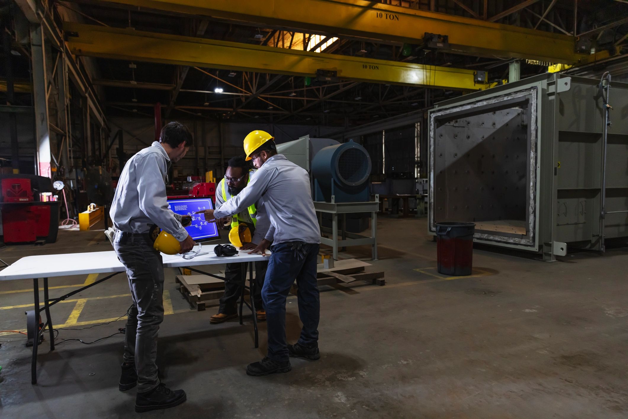 Manufacturing team reviewing production data on the factory floor