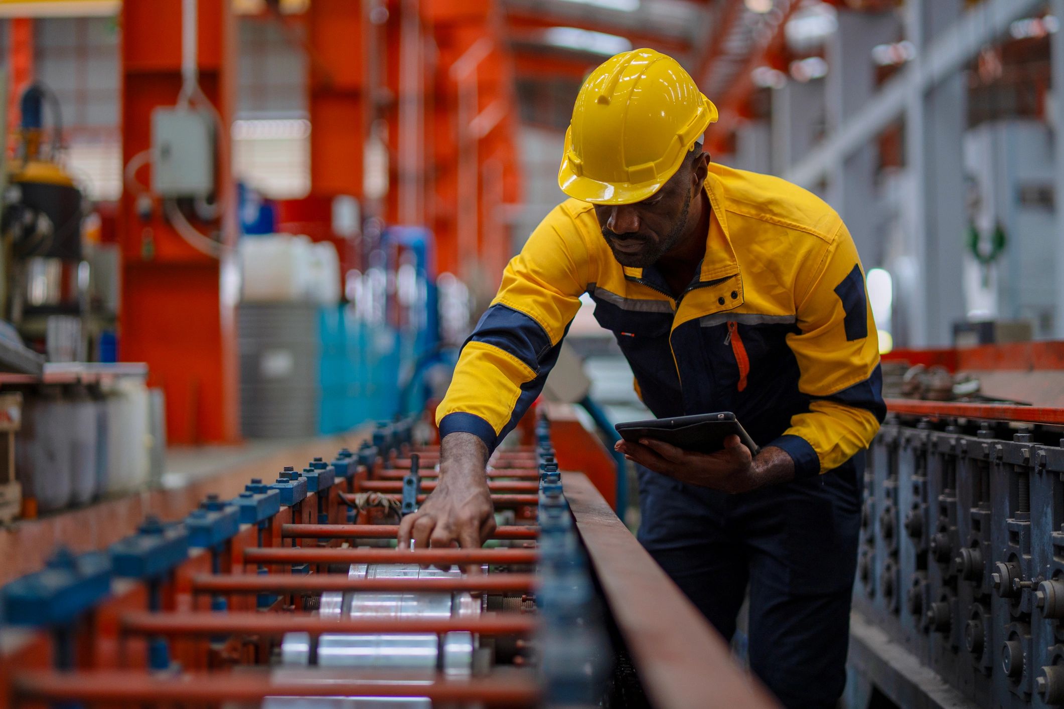 Factory engineer working with digital tools in a manufacturing facility
